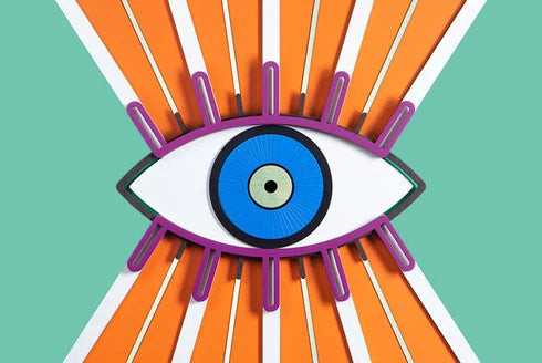 A stylized graphic illustration of a large eye centered on a mint green background with radiating orange and white stripes. The eye has a purple outline, a blue iris, and a small pale center.