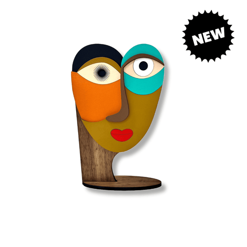 A colorful abstract wooden sculpture of a stylized face with two eyes - Umsqu