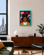 A framed  handmade wood wall mask,  featuring a stylized portrait of Mr. Basquiat with a turquoise frame, displayed on a beige wall in a modern living room setting.